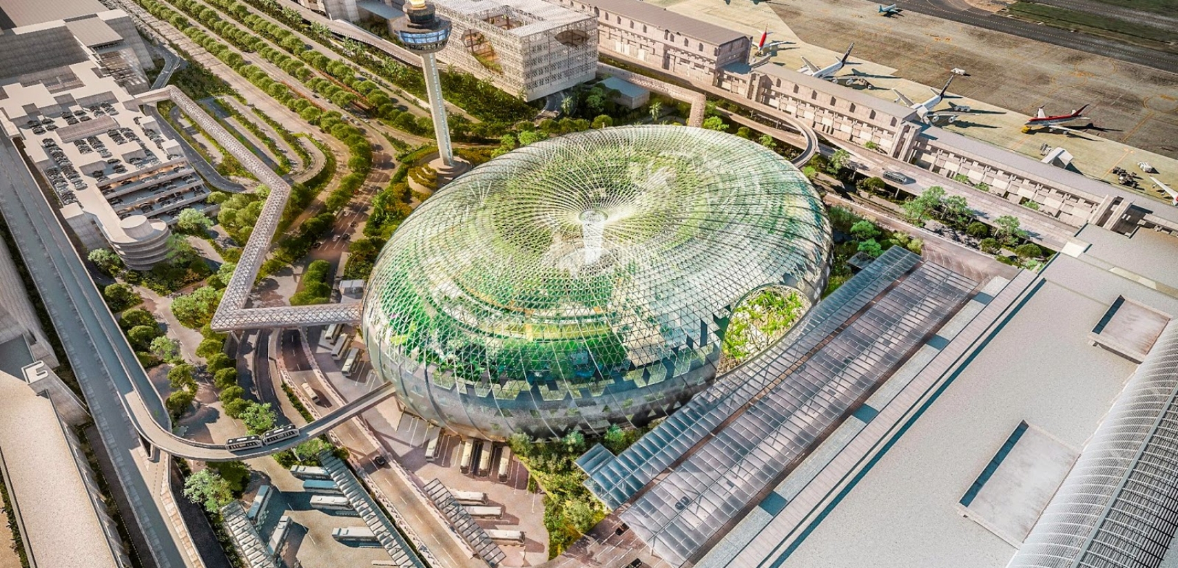 Aerial view of a modern airport terminal with a glass dome structure
